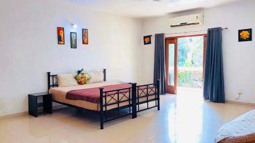 a bedroom with a bed in a room with a window at 3bhk Villa calangute in Calangute