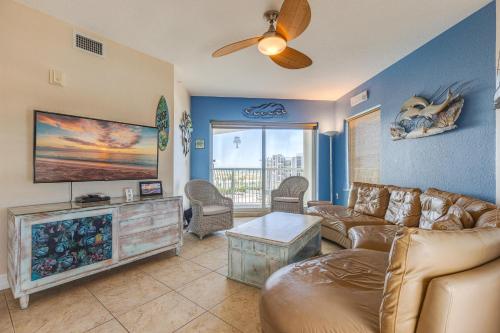 a living room with a couch and a flat screen tv at August Beach Getaway Specials Book & Save! in St. Pete Beach