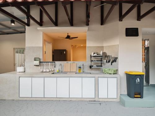 a large kitchen with white cabinets and a ceiling at Mutiara Gurney at 15, Lorong Kelawai in George Town
