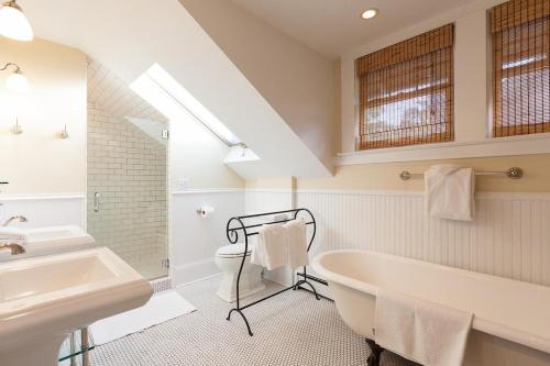 a bathroom with a sink and a tub and a toilet at Cascade Chic 30 day minimum in Hood River