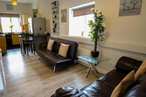 a living room with a couch and a table at The Dock, South Shields 2 bedrooms sleeps 5 long stay and contractor rates welcome in South Shields