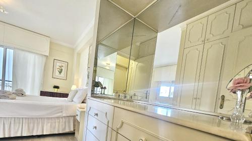 a bathroom with a bed and a large mirror at STAY Charm Classic Apartment in Strovolos