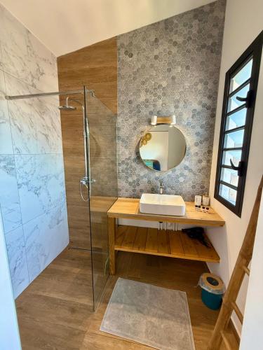 a bathroom with a sink and a shower at Aloes - Villa Salba. Panoramic view. in Étang-Salé