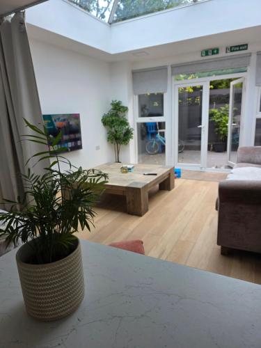 a living room with a table and a couch at Bee Hive Studio Flat in Manchester
