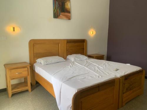 Un pat sau paturi într-o cameră la Résidence Keur RAMA -Chambres d'hôtes