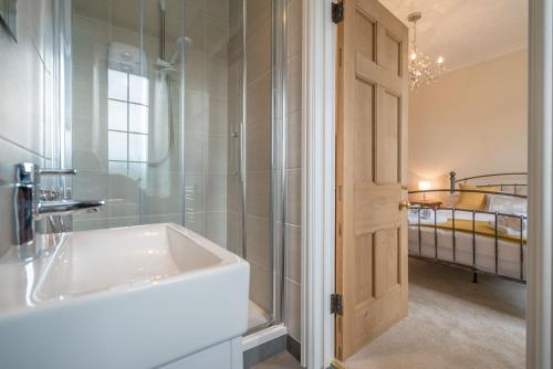 a bathroom with a sink and a shower at Ficerdy in Llanwnda