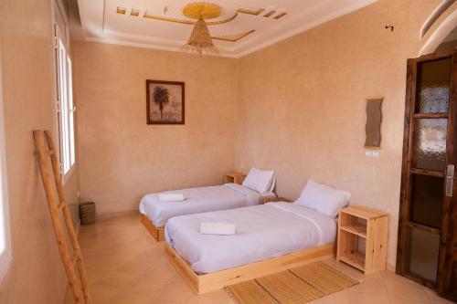 a bedroom with two beds in a room at Surf & bask HOME in Tamraght Ouzdar
