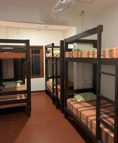 a group of bunk beds in a room at One More Day Hostel, Weligama Beach in Weligama