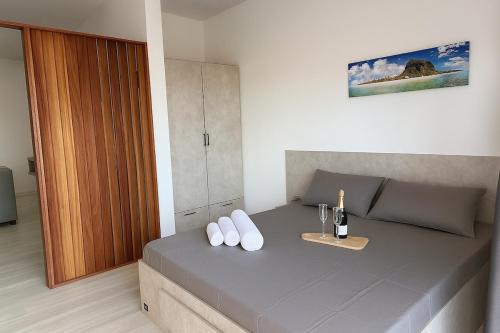 a bedroom with a bed with a bottle of wine at Suite Sky and Sea in Flic-en-Flac