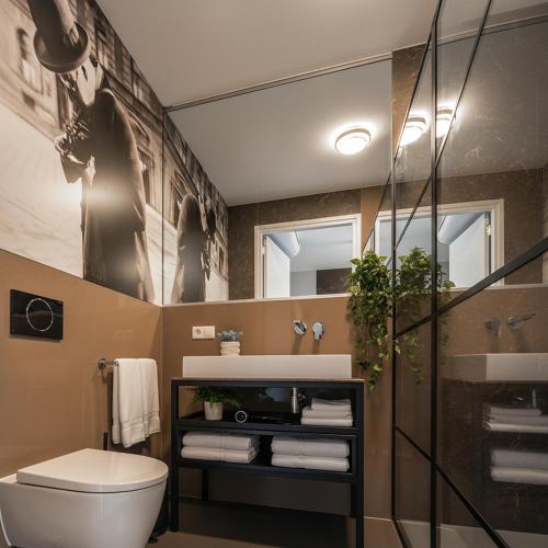 a bathroom with a toilet and a sink and a mirror at Central New Tilburg apartments in Tilburg