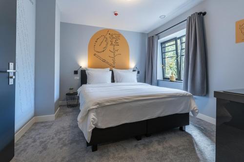 a bedroom with a large bed and a window at Central New Tilburg apartments in Tilburg