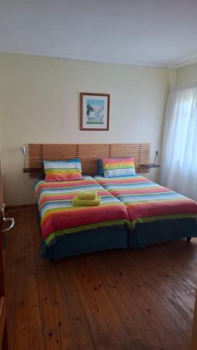 a bedroom with a bed with two towels on it at The Cottage, Heide Avenue in Somerset West