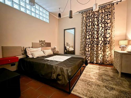 a bedroom with a bed and a large window at Apartment In Villa With Pool On Umbrian Hills in Stroncone