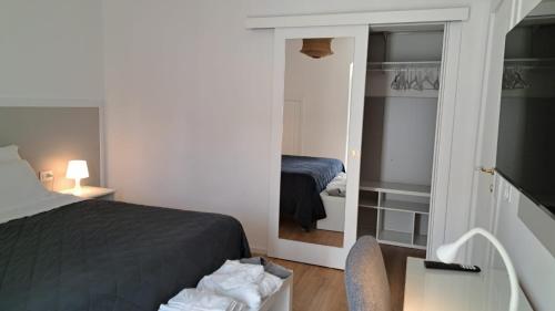 a small bedroom with a bed and a mirror at Antica Dimora Petito Luxury Suites in Matera