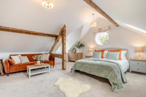 a bedroom with a bed and a couch at 3 Bed in Upper Sapey oc-s33623 in Upper Sapey