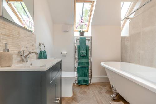 a bathroom with a sink and a tub and a toilet at 3 Bed in Upper Sapey oc-s33623 in Upper Sapey