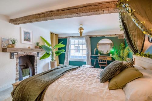 a bedroom with a large bed and a fireplace at 3 Bed in Wotton-under-Edge oc-l33488 in Wotton under Edge