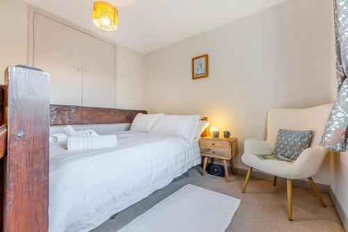 a bedroom with a large bed and a chair at 2 Bed in Ingleton oc-n33612 in Ingleton 