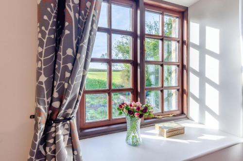 a vase of flowers sitting on a window sill at 2 Bed in Ingleton oc-n33612 in Ingleton 