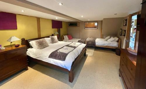 a hotel room with two beds and a television at The Lodge, Smarden in Smarden