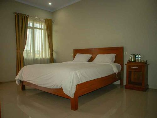 Una cama o camas en una habitación de Hotel Inayah Syariah