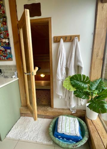 a bathroom with an open door with a towel at The Lodge, Smarden in Smarden