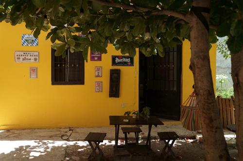 a table and chairs in front of a yellow building at Habitacion Azul / Casa del Café in Campeche