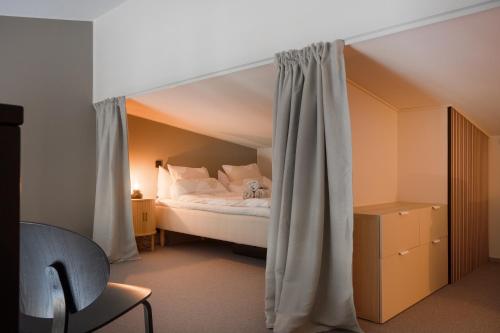 a bedroom with a bed with a canopy at Auroras by Kaltios, Gielas, Ski-in Ski-out, Mountain view in Kittilä
