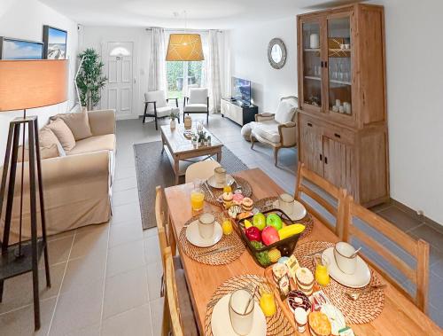 a living room with a table with food on it at Un Temps Pour Nous - Downtown house near beach in Cucq