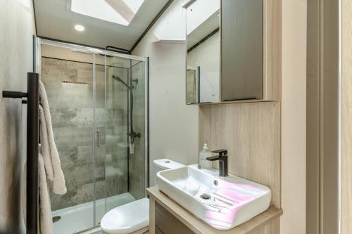 a bathroom with a sink and a shower at 2 Bed in Hendra Croft oc-h32360 in Cubert