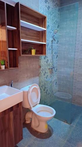 a bathroom with a toilet and a sink and a shower at Appartement Aéroport Sunset Marrakech in Marrakesh