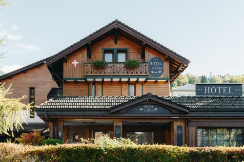 a wooden hotel building with a sign on it at Hôtel des 2 Gares in Saint-Gervais-les-Bains