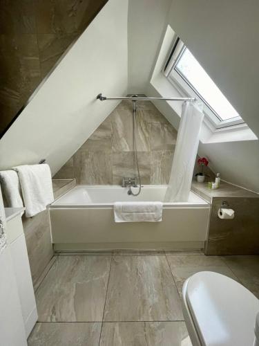 a bathroom with a bath tub in a attic at Shandon Bells Guest House in Cork