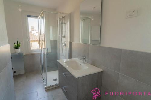 a bathroom with a sink and a shower at Tetti di Parma in Parma