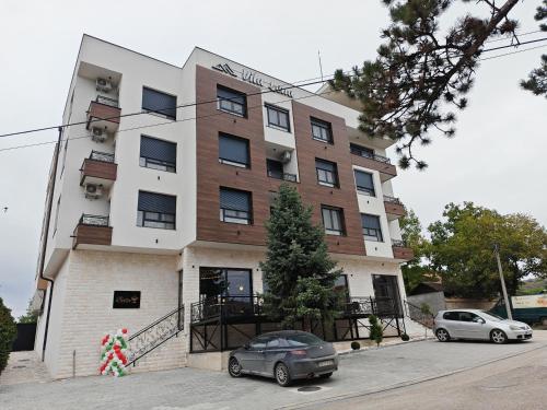 a building with a car parked in front of it at POOL RESORT Vila Lena - Lux residence apartman 1 in Vrdnik