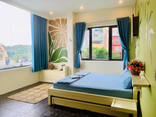a bedroom with a bed and a window at The Little Leaf Hostel - Restaurant & Rooptop Bar in Cat Ba