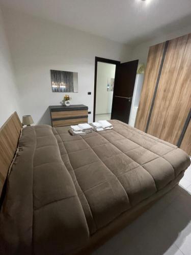 a bedroom with a large bed with two towels on it at Dimora del Sole in Brindisi