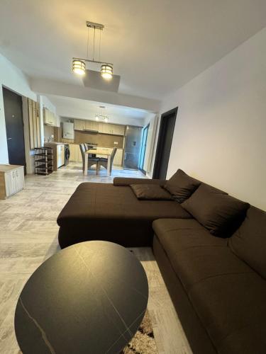 a living room with a couch and a table at Madona Apartment in Craiova