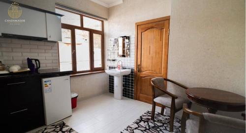 a kitchen with a table and a sink and a table at GREENChashmasor in Dushanbe