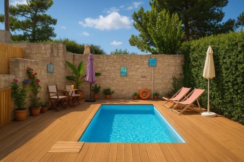 a swimming pool with chairs and a table and an umbrella at Geo heaven glamp in Aïtánia