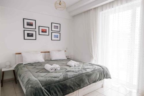 a bedroom with a bed with two towels on it at comfort apartment in Tripoli