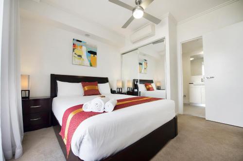 a bedroom with a large bed with towels on it at Gladstone Central Plaza Official in Gladstone