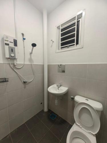 a bathroom with a shower and a toilet and a sink at SWee Garden Homestay in Kota Tinggi