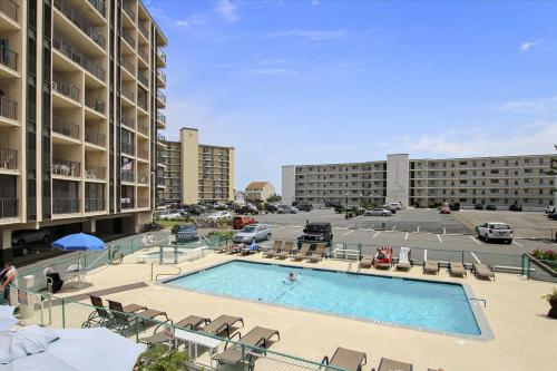a large swimming pool in a parking lot with buildings at Bluewater East 407 S in Ocean City