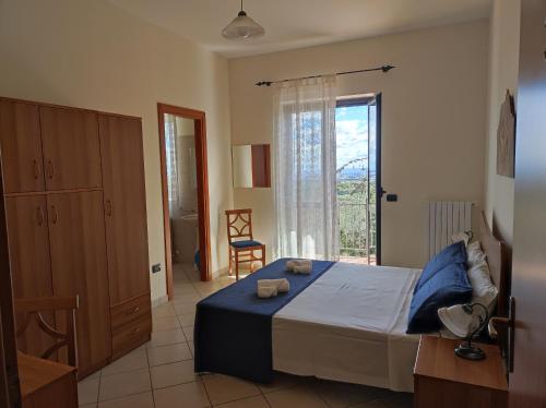a bedroom with a bed and a large window at Nonno Pierino affittacamere in Civitella Casanova