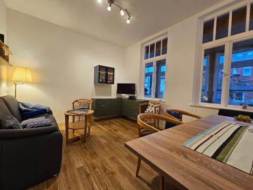 a living room with a couch and a table at Haus Wendland Haus Wendland in Norderney
