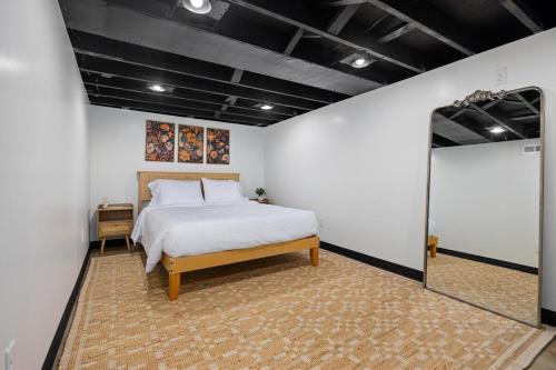 a bedroom with a large bed and a mirror at Heights Haus in Peoria Heights