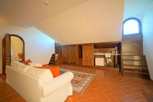 a living room with a white couch and a table at Historic Villa In The Tuscan Woods And Hills in Casteldelci