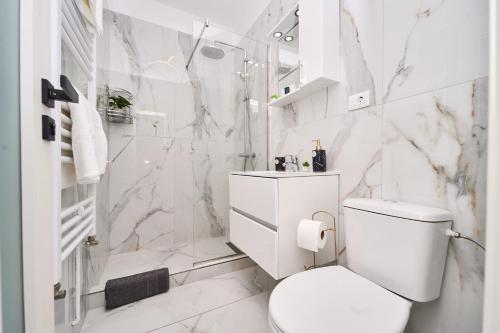 a white bathroom with a toilet and a shower at KIM & C O Loft - Evadare Romantică - By Open House in Timişoara