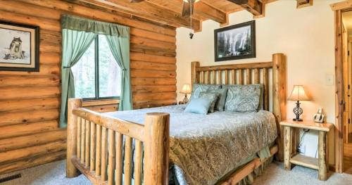 a bedroom with a bed in a log cabin at Cozy three bedroom cabin in Duck Creek in Duck Creek Village